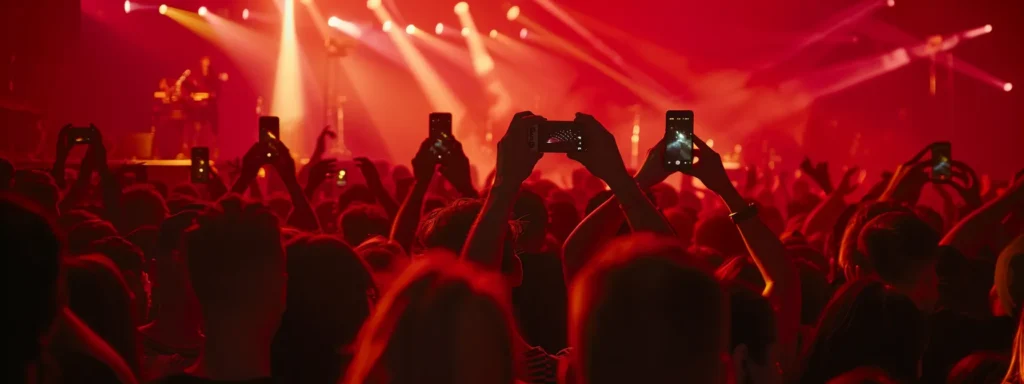 crowd of people taking photos with their phones at a music concert.