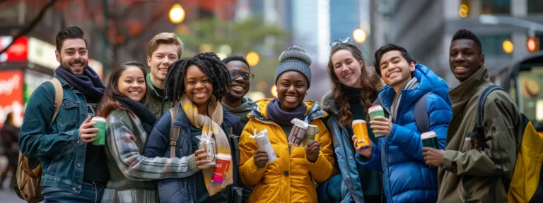 a diverse group of smiling people holding up products and looking directly at the camera in a bustling city square.